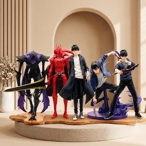May include: A collection of five anime-style character figures standing on a tan base. The group includes a purple and black armored creature with a long sword, a red armored figure, a central figure in a black coat, and two dynamic figures in blue.