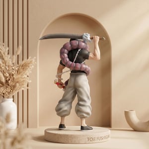 May include: A figurine of a character from the anime series Jujutsu Kaisen. The figure is of Toji Fushiguro, wearing a black shirt, light gray pants, and black shoes. He carries a large sword and a chain with a red weapon. The base reads "TOJI FUSHIGURO."