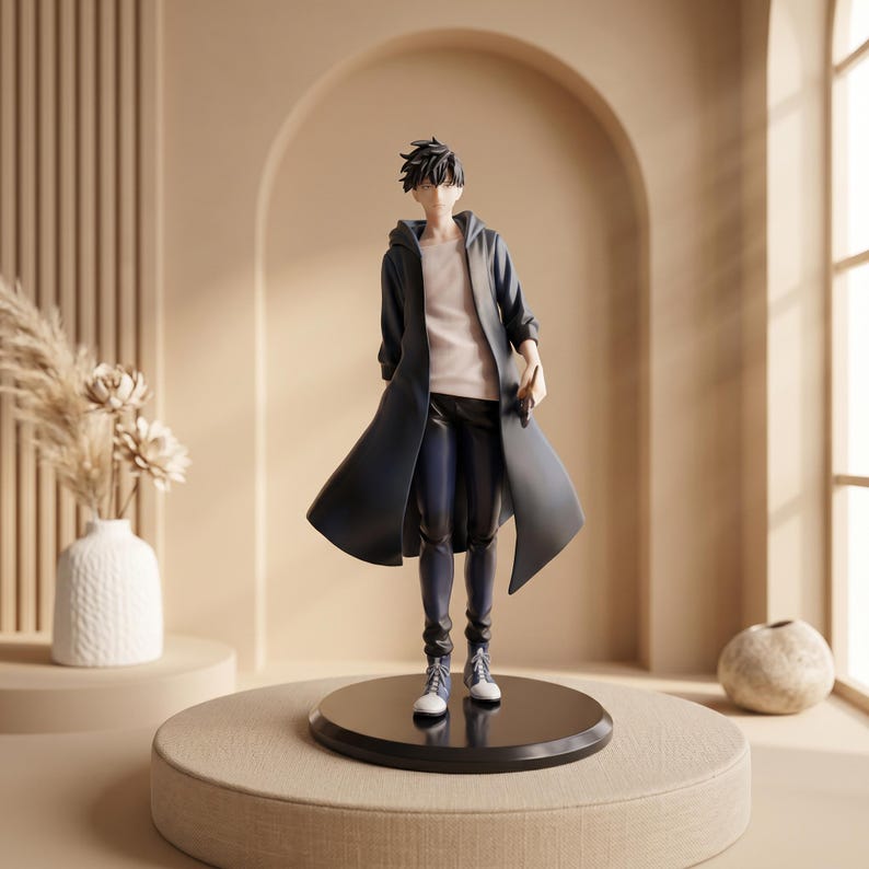 May include: A standing anime-style figurine of a character with spiky black hair, wearing a long dark blue hooded coat over a white t-shirt and dark pants. The figure is positioned on a circular black base, featuring white and blue sneakers.
