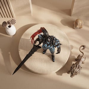 May include: A black action figure of a knight with a long sword, blue accents, and red hair stands on a beige circular platform. A small white vase with dried seed pods, and a carved stone head and lion figurine are also present.