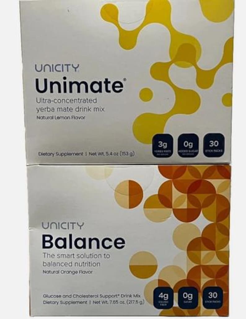 May include: Two Unicity dietary supplement boxes. The top box is Unimate ultra-concentrated yerba mate drink mix in natural lemon flavor, net weight 5.4 oz (153 g). The bottom box is Balance drink mix in natural orange flavor, net weight 7.65 oz (217.5 g).