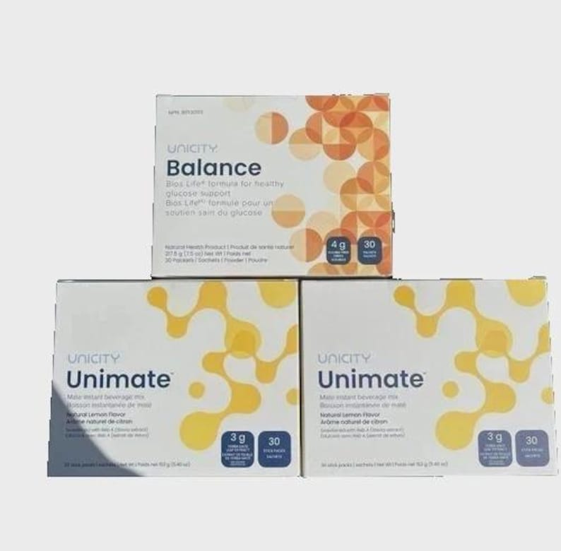 May include: Three rectangular boxes of Unicity dietary supplements. The top box is labeled Balance with orange circular patterns, weighing 217.5 g (7.5 oz). The two bottom boxes are labeled Unimate with yellow molecular patterns, weighing 153 g (5.4 oz).