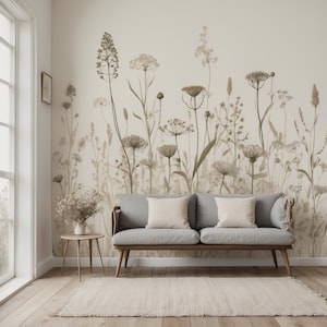 May include: A living room with a grey sofa, cream cushions, and a wooden side table. A beige rug sits on the wooden floor. The wall features a floral mural in beige and brown tones, creating a natural and calm atmosphere.