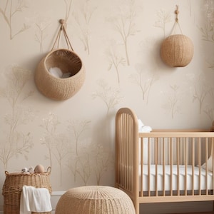 May include: A neutral-toned nursery featuring a wooden cot, woven baskets, and a round ottoman. The walls are decorated with floral wallpaper. Hanging woven baskets and a round woven ball enhance the room's decor. The room has a calming, neutral colour scheme.