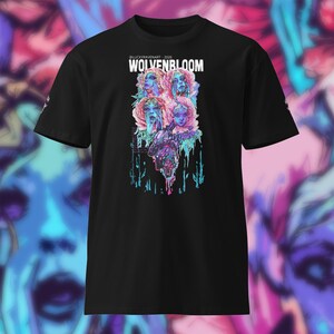 May include: A black short-sleeve t-shirt featuring a graphic print with the text WOLVENBLOOM and @LUCKYRAVENART - 2026. The design displays four stylized faces surrounded by pink and blue floral elements with dripping paint effects in cyan and magenta.