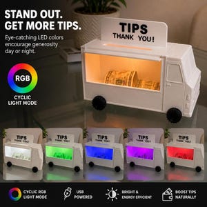 May include: A white food truck-shaped tip jar with an illuminated interior featuring RGB LED lighting. The top sign displays the text TIPS THANK YOU! The container is USB powered and includes a cyclic light mode that cycles through various colors.