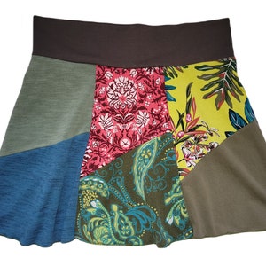 May include: A patchwork skirt with a brown waistband and a variety of floral patterns in shades of pink, green, blue, and yellow.