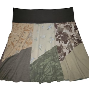 May include: A patchwork skirt with a brown waistband and a variety of floral patterns in shades of brown, green, and beige.