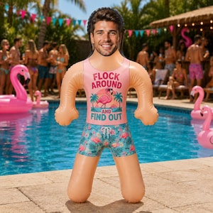 May include: An inflatable pool float shaped like a person with a custom photo face. The figure wears a pink tank top with a flamingo graphic and the text FLOCK AROUND AND FIND OUT, paired with blue swim trunks featuring a tropical flamingo pattern.