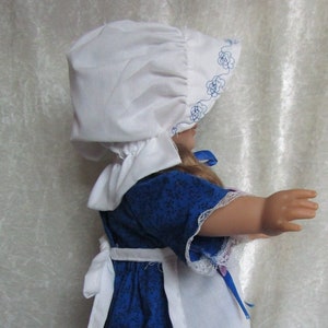 Vestito blu da pioniera con grembiule ricamato e cuffia per bambole da 18 pollici.