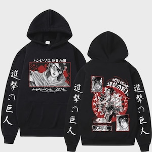 May include: Black hoodie featuring anime-style graphics. The front displays a character portrait with Japanese text and the name "HANGE ZOE." Sleeves have vertical Japanese text. The back showcases a larger graphic with multiple character images and Japanese text. A hooded sweatshirt.