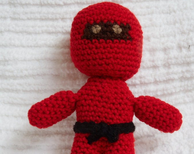 Red Ninja doll Crocheted ninja in red with black belt/sword and brown eyes.