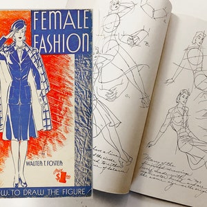 May include: Vintage book titled "FEMALE FASHION" by Walter T. Foster, with a blue and orange cover illustration of a woman in a blue suit and coat. The book is open to show figure drawing sketches. The text "HOW TO DRAW THE FIGURE" is at the bottom.