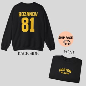 May include: Black sweatshirt with the name "ROZANOV" and the number "81" in yellow block letters on the back. The front of the sweatshirt displays "BOSTON RAIDERS" in yellow. The words "BACK SIDE" and "FONT" are also visible.
