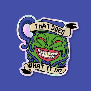 May include: A holographic sticker featuring a cartoon face with a wide grin and red eyes. The face is green with blue accents and a banner that reads "THAT DOES WHAT IT DO". The sticker has a blue handle and is set against a blue background.