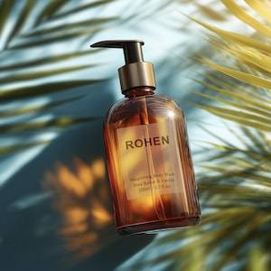 May include: A brown glass bottle of "ROHEN" nourishing body wash with a black pump and gold accents. The label reads "Shea Butter & Vanilla" and "200ml / 6.7 fl oz". The bottle is set against a blue background with palm leaves.