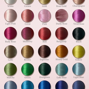 May include: A color chart of embroidery thread, featuring a variety of colors such as white, pink, red, green, and blue. The text "Embroidery Thread Colors" and "Choose Your Favorite" are displayed at the top.