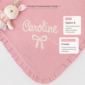 May include: A pink baby blanket with the name "Caroline" embroidered in cream-colored thread. The blanket has a ruffled edge and a cream-colored bow design. A stuffed bunny toy is in the upper left corner. The text "Product Customization Guide" is at the top.