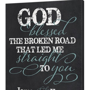 May include: Black chalkboard sign with white and blue text. The text reads "God blessed the broken road that led me straight to you" with the names "James and Karen" and the date "Est. 9-6-14" below.
