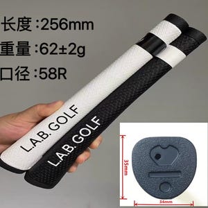 May include: Two golf club grips, one white and one black, with the text "L.A.B. GOLF" printed on them. The grips are 256mm long and weigh 62g. A small, dark gray end cap is also shown, measuring 1.38 inches by 1.34 inches.