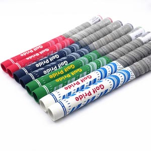 May include: A selection of golf club grips in a range of colours, such as red, navy, green, and white. Each grip is printed with the text "Golf Pride" in white. The grips are arranged diagonally against a white backdrop.