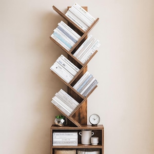 May include: A wooden bookshelf with a unique zig-zag design, filled with books. The bookshelf is a dark brown color and has multiple shelves. A small clock, a plant, and other decorative items are on the bottom shelf.