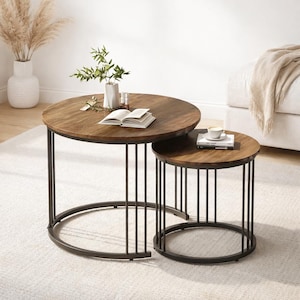 May include: Two round nesting coffee tables. The tables have dark brown wooden tops and black metal frames. The larger table has a diameter of approximately 36 inches, while the smaller table is about 24 inches in diameter. A book and a cup of coffee are on the tables.