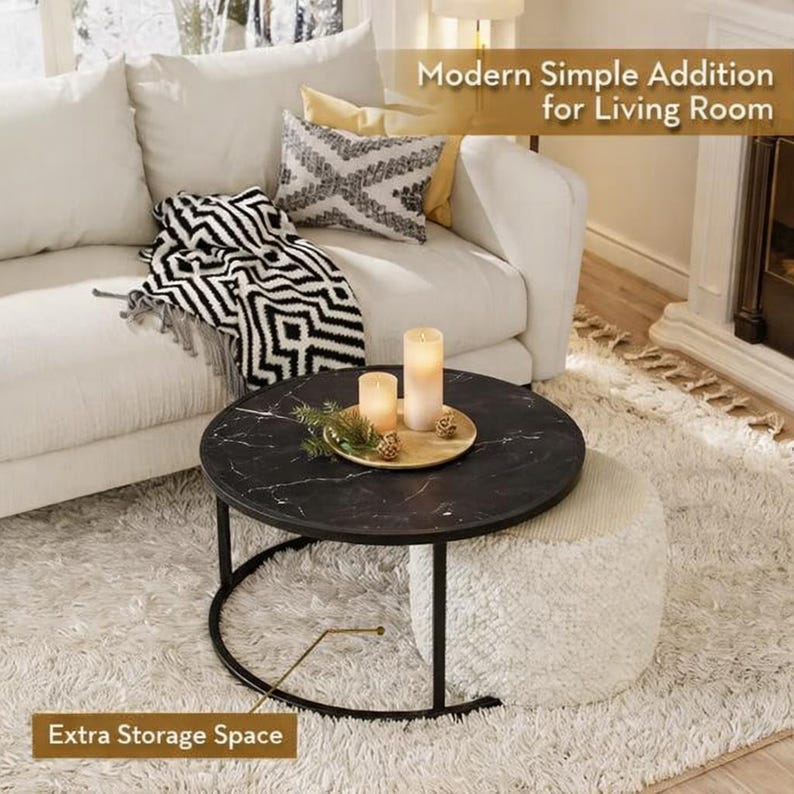 May include: A modern living room scene featuring a round black marble-topped coffee table with a black metal frame. The table holds candles and a decorative tray. A white ottoman sits beneath the table. The text reads "Modern Simple Addition for Living Room" and "Extra Storage Space."