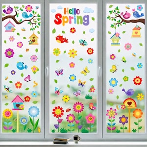 May include: A window decorated with colorful spring-themed decals. The decals include flowers, butterflies, birds, birdhouses, and the words "Hello Spring." The design is vibrant and cheerful, with a variety of colors and shapes.