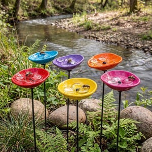 May include: A set of three ceramic mugs with a speckled, matte finish. The mugs are in shades of cream, light gray, and dark gray. Each mug has a simple, minimalist design and a rounded handle.