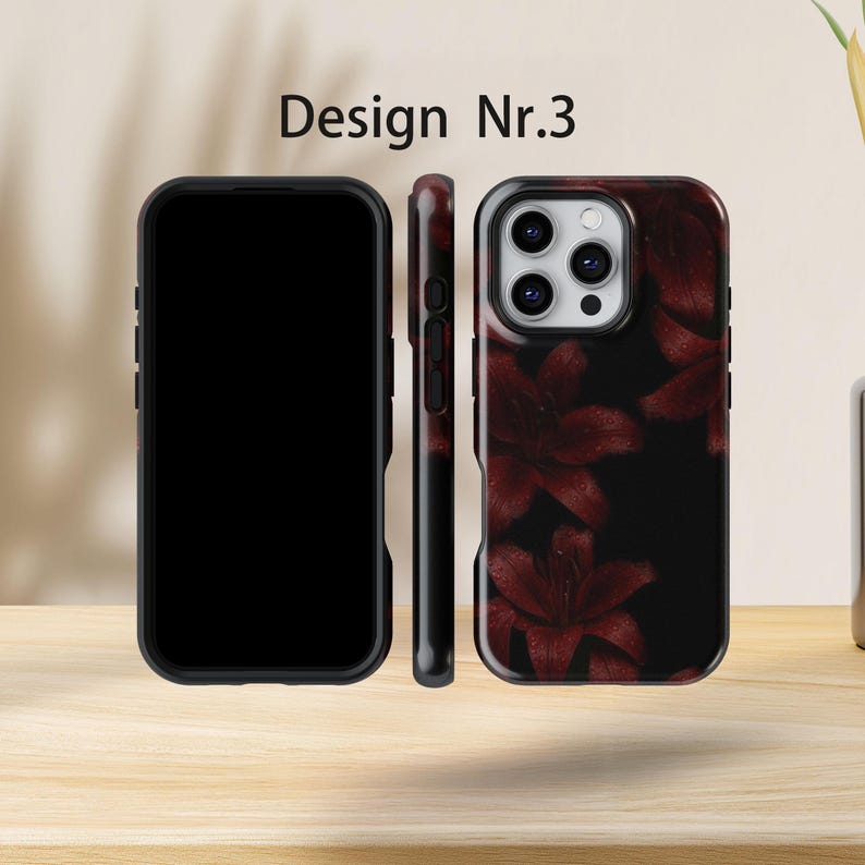 May include: Black phone case featuring a dark red floral pattern of lilies against a black backdrop. The case is displayed from multiple angles, with the text "Design Nr.3" visible at the top.