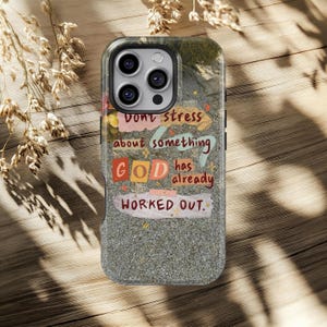 May include: A phone case with a textured grey background and the text "Don't stress about something GOD has already WORKED OUT." The case has a clear border and a camera cutout.
