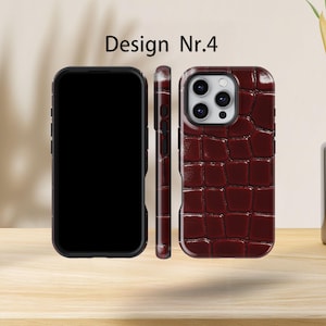 May include: Three phone cases displayed, featuring a burgundy crocodile-effect design. The cases are black and burgundy. The text "Design Nr.4" is at the top. The cases are displayed in a row.