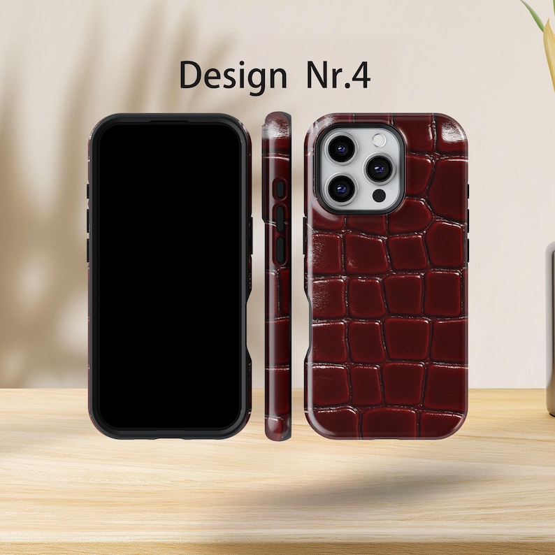 May include: Three phone cases displayed, featuring a burgundy crocodile-effect design. The cases are black and burgundy. The text "Design Nr.4" is at the top. The cases are displayed in a row.