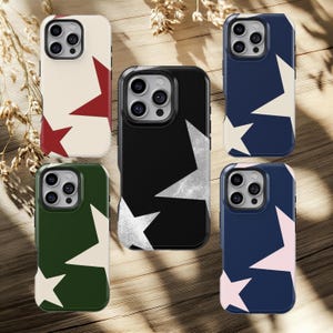 May include: A collection of phone cases with star patterns. The cases feature a variety of colors, including cream with red stars, black with white stars, navy blue with white and pink stars, and green with white stars. The cases are designed to fit a smartphone.