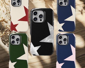 May include: A collection of phone cases with star patterns. The cases feature a variety of colors, including cream with red stars, black with white stars, navy blue with white and pink stars, and green with white stars. The cases are designed to fit a smartphone.