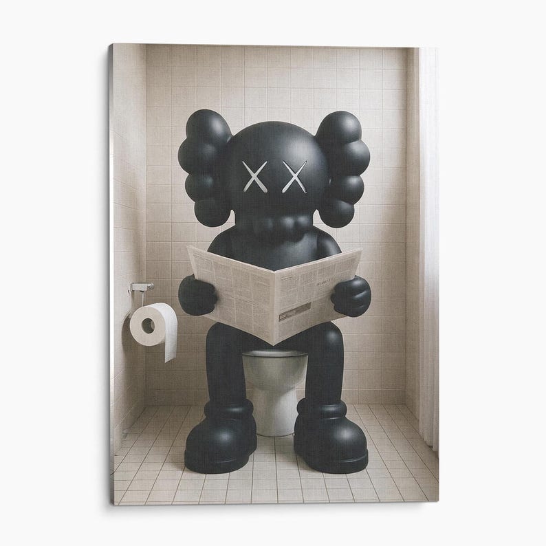 May include: A matte black KAWS Companion figure with signature X-shaped eyes sits on a white toilet, holding an open newspaper. The figure features rounded ears and large, bulbous limbs, positioned in a tiled bathroom with a toilet paper roll holder.
