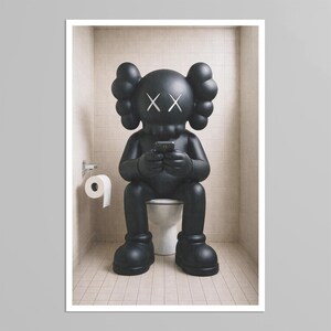 May include: A matte black KAWS Companion figure with signature X-shaped eyes sits on a white toilet, holding a small black smartphone. A roll of white toilet paper hangs on a silver holder attached to the tiled wall beside the figure.