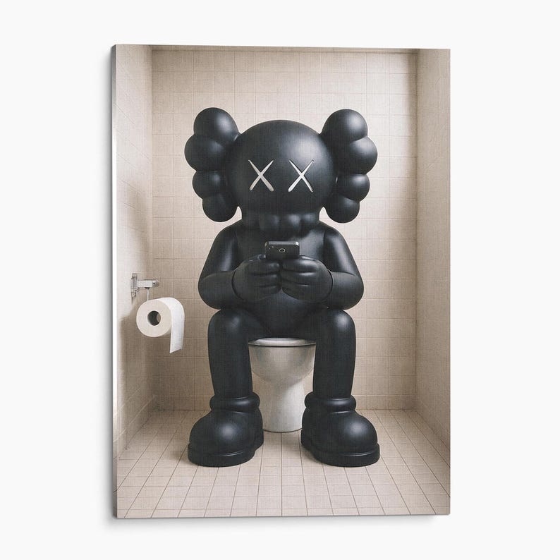 May include: A matte black KAWS-style character figure with X-shaped eyes and rounded ears, sitting on a white toilet while holding a small black smartphone. A roll of white toilet paper hangs on a silver holder attached to the tiled wall nearby.