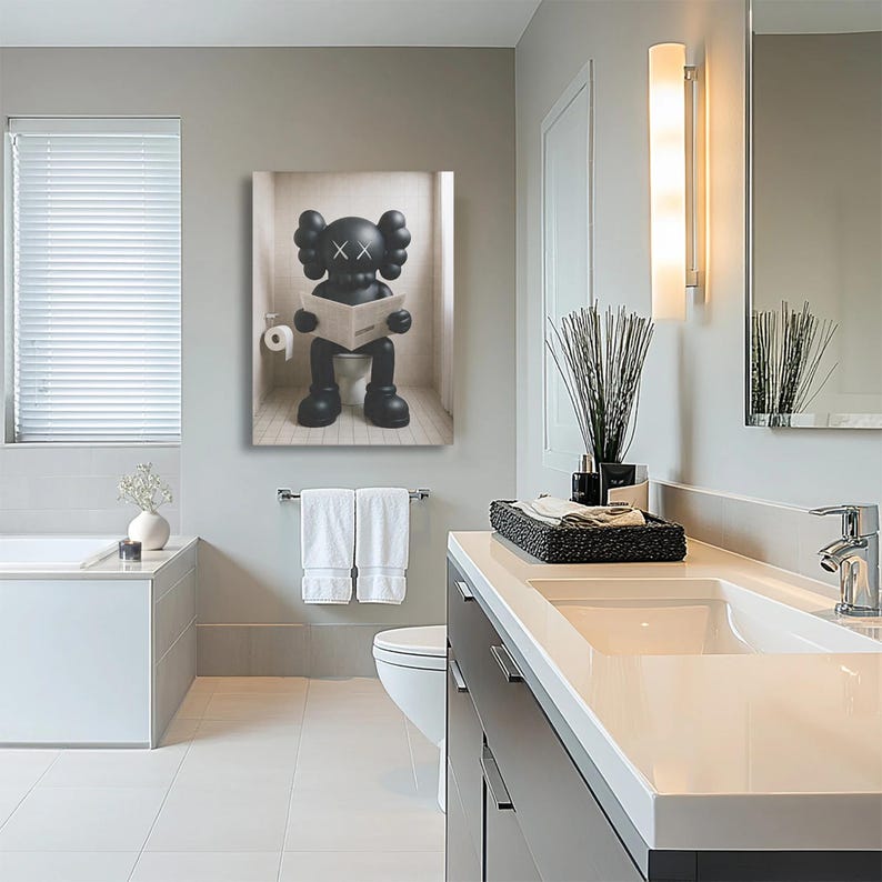 May include: A rectangular wall art print featuring a black cartoon character with X-shaped eyes sitting on a toilet and reading a newspaper. The character has rounded ears and large hands, depicted in a minimalist style against a light background.