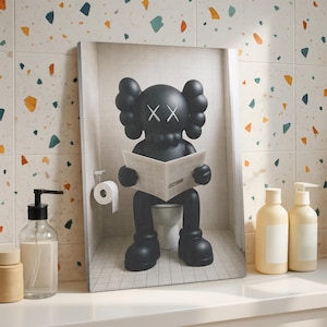 May include: A rectangular wall art print featuring a black cartoon character with X-shaped eyes sitting on a white toilet and reading a newspaper. The character has rounded ears and large hands. The scene is set in a tiled bathroom with a toilet paper roll.