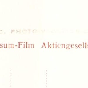 May include: A cream-coloured vintage postcard featuring text and a logo. The text reads "Universum-Film Aktiengesellschaft, Berlin-Tempelhof" and "FK 3648". The logo is a red diamond shape with a stylized design.