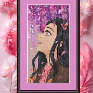 May include: Framed cross-stitch art featuring a character with long black hair and pink eyes, looking upwards. The background shows purple wisteria flowers. The artwork is in a black frame with a pink mat.