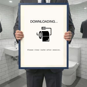 Può includere: Una stampa incorniciata con bordo blu, tenuta da una persona in giacca e cravatta, presenta una grafica in bianco e nero di un rotolo di carta igienica con il testo "DOWNLOADING..." e "Please clear cache after session."