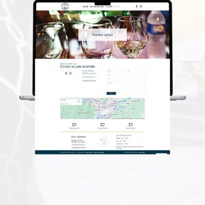 May include: A laptop displays a website with a wine theme. The top banner features wine glasses and pouring wine. The website includes the text "Prendre contact" and "&Eacute;crivons la suite ensemble". A map and contact information are also visible.