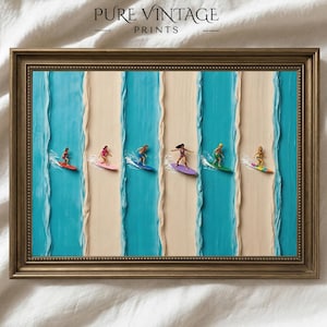 May include: Framed print featuring a beach scene with surfers on colorful surfboards. The artwork has a textured appearance with vertical stripes of blue and beige. The frame is a gold color, and the text "PURE VINTAGE PRINTS" is at the top.