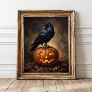 May include: A framed wall art print featuring a black raven perched atop a glowing, carved jack-o'-lantern pumpkin. The scene is set against a dark, moody background with scattered autumn leaves on the ground, all encased in a rustic wooden frame.