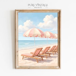 May include: A framed beach scene print featuring pink and white striped umbrellas and matching lounge chairs on a sandy beach. The artwork includes the text "PURE VINTAGE PRINTS" at the top.