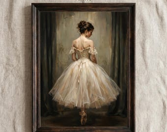 May include: A framed print of a ballerina in a cream-colored tutu, viewed from the back. The artwork features a dark wooden frame and the text "PURE VINTAGE PRINTS" at the top. The ballerina is wearing pointe shoes and is standing in front of a dark curtain.