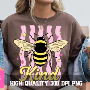 May include: Brown t-shirt with a large graphic of a bee with yellow and black stripes, wings, and the word "Kind" in yellow script. Pink wavy lines and stars surround the bee. The text "HIGH QUALITY 300 DPI PNG" is below.